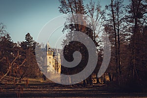 Old castle with a beautiful spring park in Goluchow, Poland. Travel in Europe. Historical monument.