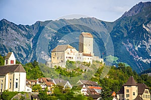 Old castle in front of mountains Alps near Vaduz town, Liechtenstein