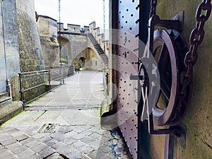 Old castle gate with drawbridge mechanics in medieval fortress photo