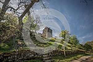 Old castle ruin on sunny hill with stone walls