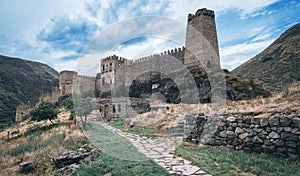 Old castle in the state among the mountains under a stormy sky