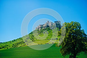 Old castle in Tatra mountains with blue sky background.