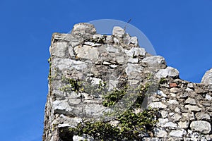 Old castle tower ruins against clear blue sky