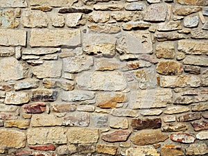 Old castle wall, antique natural stone wall. Pattern gray color, decorative uneven cracked real stone wall surface with cement