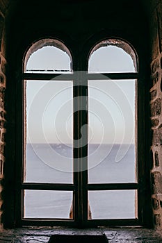 Old castle window overlooking the sea, middle ages