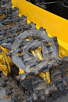 Old caterpillar on yellow tractor
