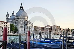 Old cathedral of Santa Maria della Salute in Venice and moored gondolas in Venice