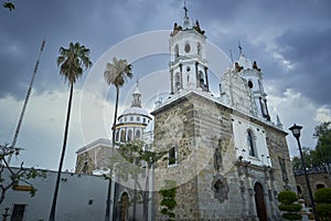 Old Catholich church with palm trees in Latin America