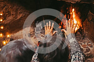 Old caucasian couple keeping hands warm at home. Senior aged husband and wife relaxing while opening palm of hands for warming at