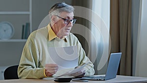 Old Caucasian male elderly businessman teacher man lawyer sitting at table has video call conference remote consultation