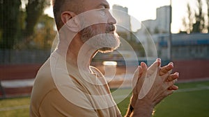 Old Caucasian man pensioner sporty retired male sportsman athlete warming up in morning training healthy lifestyle