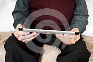 Old caucasian man using a tablet or e-reader