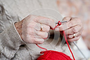 Old caucasian woman knitting