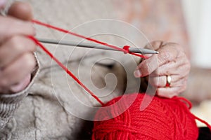 Old caucasian woman knitting