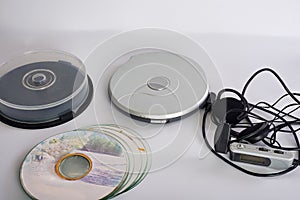 A old CD-Player with compact discs. White background. Studio shot