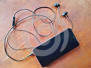 Old cell phone and headset on the table