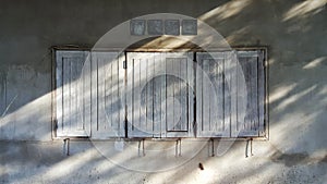 The old cement brick wall with the wooden windows.