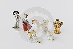 Old ceramic figurines on a white background