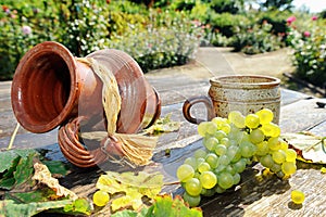 Old ceramic jug, mug and fresh grape