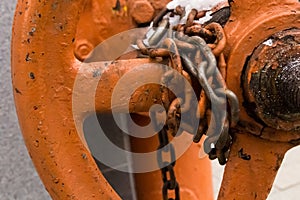 Old chain painted winded with chipped links twist the valve most of the industrial background base closed locked circle on a blurr