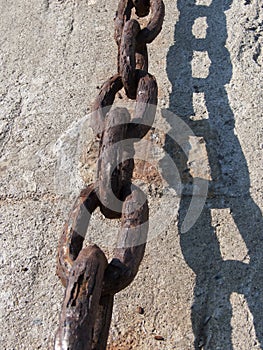 Old chain on wall at docks