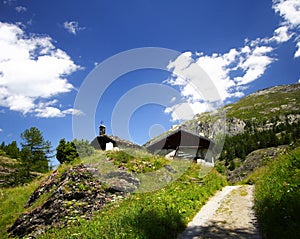 Old chapel and alps in summer