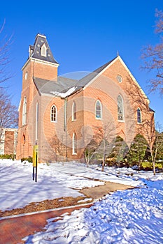 Old chapel on a college campus in winter vertical