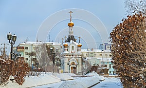 Old chapel in the middle of a winter city