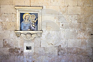 Old charity box embedded in a stone wall with copy space