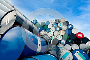 Old chemical barrels. Blue oil drum with flammable liquid symbol. Toxic waste warehouse. Hazard chemical tank with warning label.