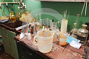 old chemical laboratory with a sink on the background of a green wall