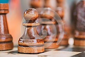 Old Chess Pawn Standing On Wooden Chessboard