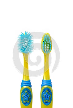 Old child toothbrush and new toothbrush on blue background