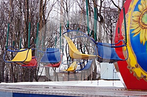 Russia. Penza. Empty seats on an old children`s carousel in the Park