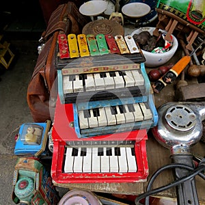 Old children& x27;s pianos on sale at Dong Tai Lu market, Shanghai, China.