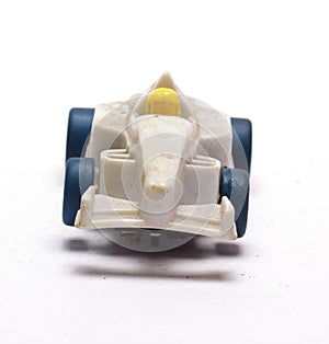 Old children`s racing car on a white background