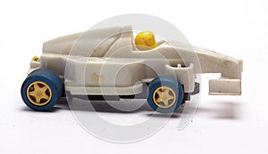 Old children`s racing car on a white background