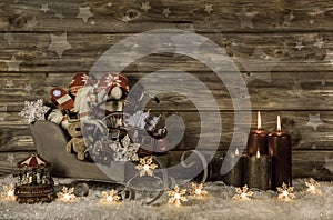 Old children toys and four burning advent candles on wooden vintage background for decoration.