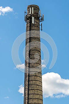 An old chimney with antennas and transmitters