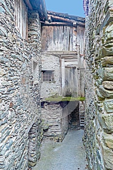 old chimney at a house with old slate roof in Caspoggio in Region Valmalenco