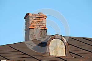 Old chimney on a house roof photo