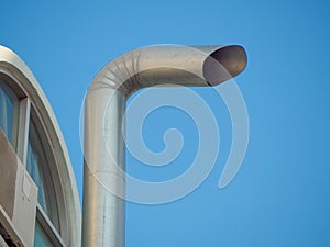 Old chimneys on the roof against the blue sky