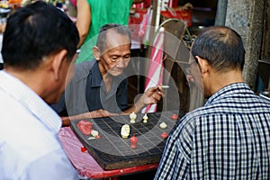Old Chinese Men play Chess