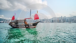 Old Chinese traditional fishing boat Junk that serves as a tourism at Victoria Habour in Hong Kong