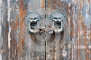 Old chinese traditional wooden gate with Lion door knockers