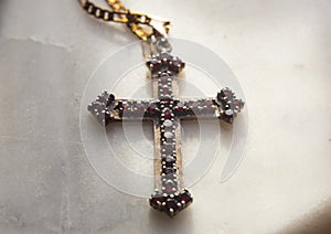 Old christian cross on alabaster background
