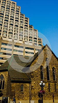 Old church building surrounded by new highrise buildings in Toronto