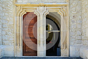 Old church entrance with open door.