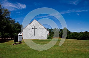 Old Church in Field with Empty Sign and Cross