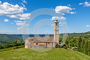 Old church on green lawn in Italy.